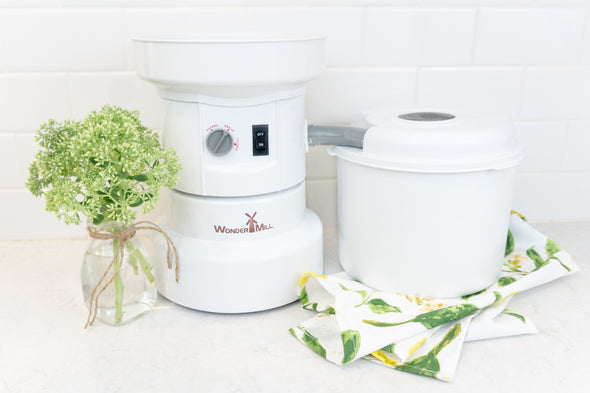 The Unsifted Starter Kit comes with the full WonderMill shown here (mill, flour cannister, cannister milling lid, cannister cup, 2 filters) plus one grey lid (not shown in this picture)